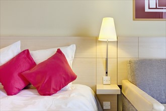 Electric lamp beside bed in luxury home. Photo : Jon Boyes