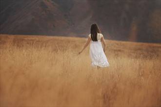 Girl (10-11) walking in wheat field. Photo : FBP