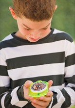 Boy (10-11) holding compass. Photo : Daniel Grill