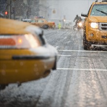 USA, New York, New York City, Close-up of yellow cab on street in snow.
