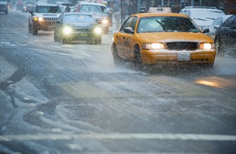 USA, New York, New York City, Traffic on street in snow.