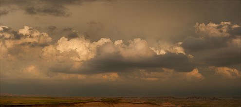 USA, South Dakota, Badlands National Park, Clouds above mountains at sunset.