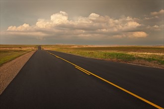 USA, South Dakota, Road in Badlands National Park at sunset.