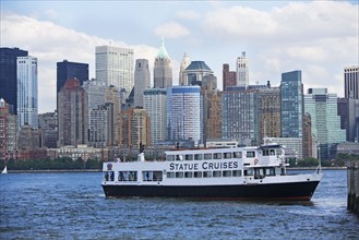 USA, New York State, New York City, Cruise ship on Hudson River, Battery Park in background. Photo