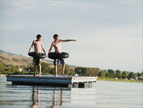Boys (10-11,12-13) jumping from raft.
