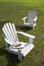 Two adirondack chairs on lawn. Photo : Chris Hackett