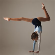 Female gymnast (12-13) performing handstand. Photo : Mike Kemp