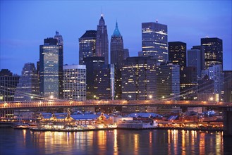 USA, New York State, New York City, Brooklyn Bridge and Manhattan skyline illuminated at dusk.
