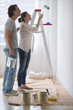 Couple painting walls.