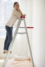 Young woman on ladder.