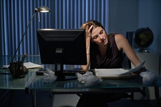 Woman working late in office.