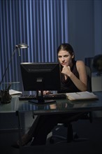 Woman working late in office.