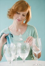 Young woman cleaning wineglasses. Photo : Jamie Grill