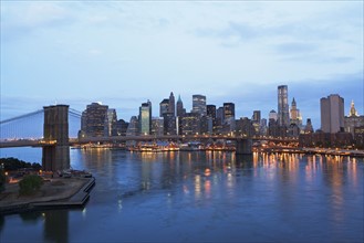 USA, New York State, New York City, Brooklyn Bridge and Manhattan skyline illuminated in early