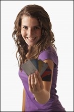 Young woman showing credit cards. Photo : Mike Kemp