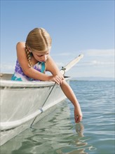 Girl (8-9) playing on boat.