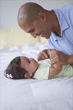Father with small girl (12-18 months).