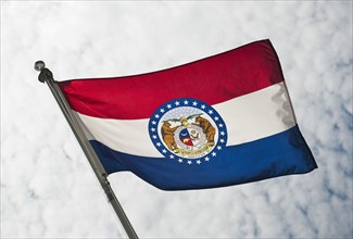 USA, Missouri State flag against sky.
