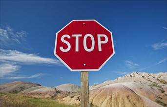 USA, South Dakota, Badlands National Park, Stop sign in mountain landscape.