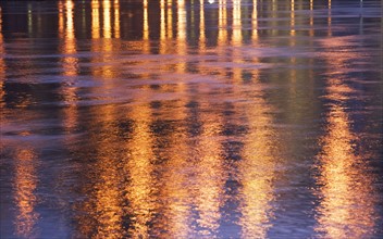 USA, New York State, New York City, City light reflecting in water surface. Photo : fotog