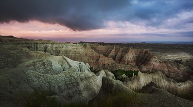 USA, South Dakota, Thick gray clouds over mountains in Badlands National Park.