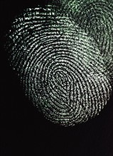Close up of fingerprint on black background.