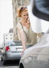 Woman looking at broken down car. Photo : Jamie Grill