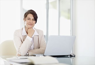 Portrait of businesswoman with laptop. Photo : Momentimages