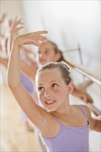 Female ballet dancer (6-8) in dance studio. Photo : Mike Kemp