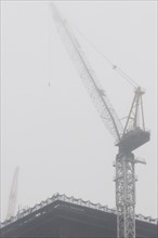 Construction crane in fog. Photo : Antonio M. Rosario