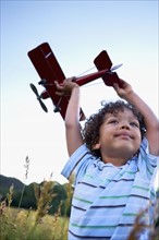 Boy (2-3) playing with toy aeroplane. Photo : Shawn O'Connor