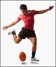 Male rugby player kicking ball. Photo : Mike Kemp