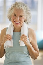 USA, New Jersey, Jersey City, Portrait of senior woman with towel at gym.