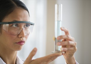 USA, New Jersey, Jersey City, Female scientist holding chemical test tube.