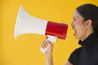 Woman shouting through megaphone.