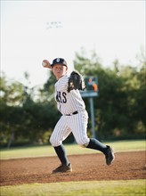 Boy (10-11) playing baseball.