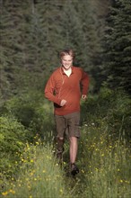 Canada, British Columbia, Fernie, young man jogging in forest. Photo : Dan Bannister