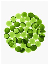 Studio shot of green glass beads in sphere. Photo : David Arky