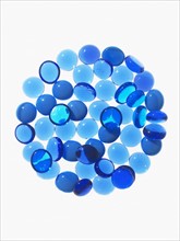 Studio shot of blue glass beads in sphere. Photo : David Arky