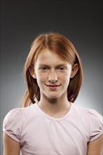 Portrait of redhead girl (10-11), studio shot. Photo : FBP