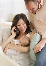 USA, New Jersey, Jersey City, Father watching baby daughter (2-5 months) as mother is using
