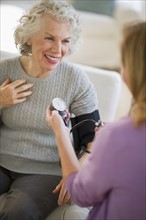 USA, New Jersey, Jersey City, Female nurse checking patients blood pressure.