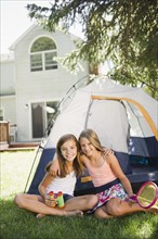 USA, New York, Two girls (10-11, 10-11) playing with tent in backyard. Photo : Jamie Grill