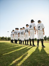 USA, California, Ladera Ranch, little league players (aged 10-11) on field.