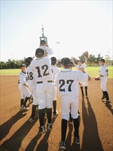 USA, California, Ladera Ranch, little league players (aged 10-11) celebrating.