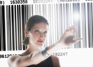 Young woman standing by barcode.