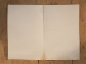 Blank page on wooden table.