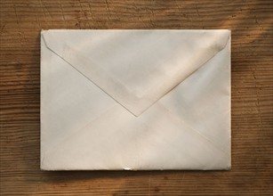Blank envelope on wooden table.