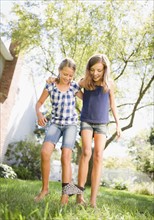 USA, New York, Two girls (10-11, 10-11) playing in backyard. Photo : Jamie Grill Photography