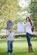 USA, New York, Flanders, Mother and son (8-9) doing laundry. Photo : Jamie Grill Photography